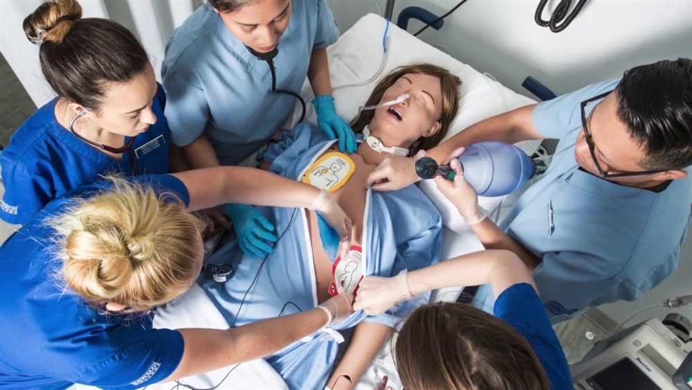 Healthcare professionals practice resuscitation on a manikin